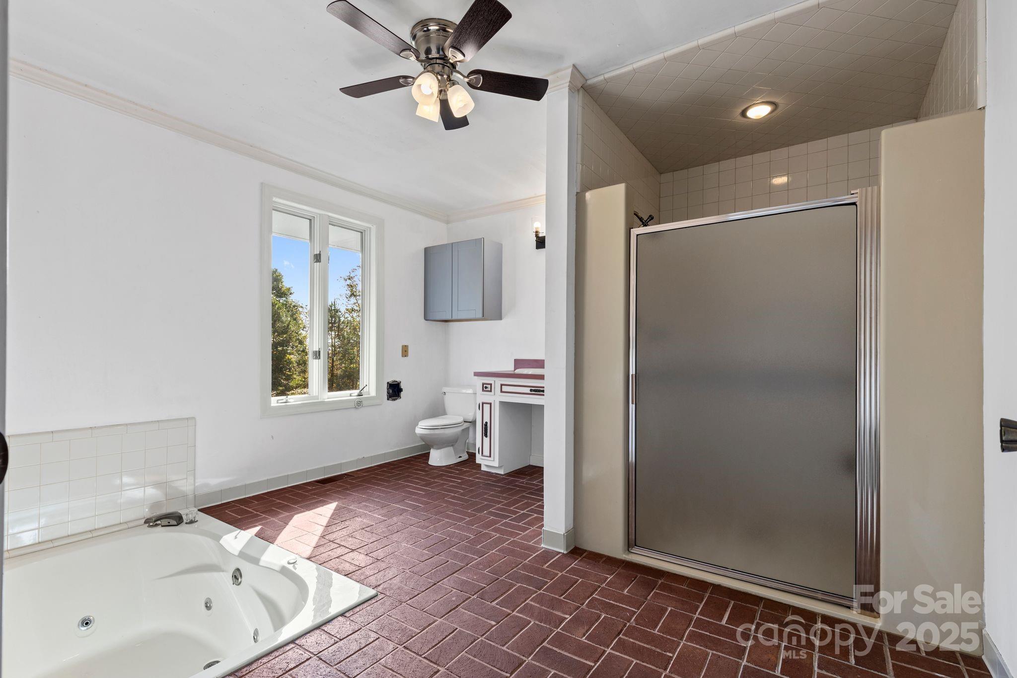 1653 Dudley Shoals Road Granite Falls, NC 28630 - Photo 21 of 48 a spacious bathroom with a bathtub and a shower