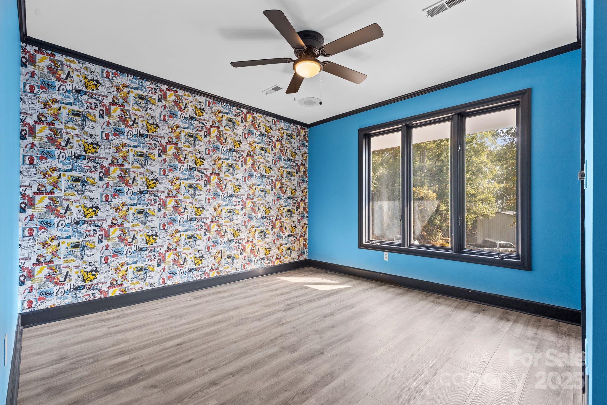 1653 Dudley Shoals Road Granite Falls, NC 28630 - Photo 31 of 48 a view of an empty room with a window and wooden floor
