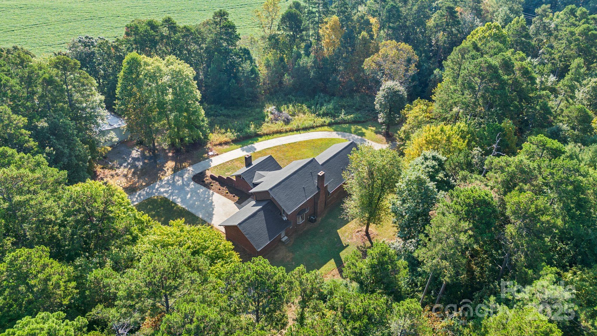 1653 Dudley Shoals Road Granite Falls, NC 28630 - Photo 45 of 48 an aerial view of a house with a yard swimming pool and lake view