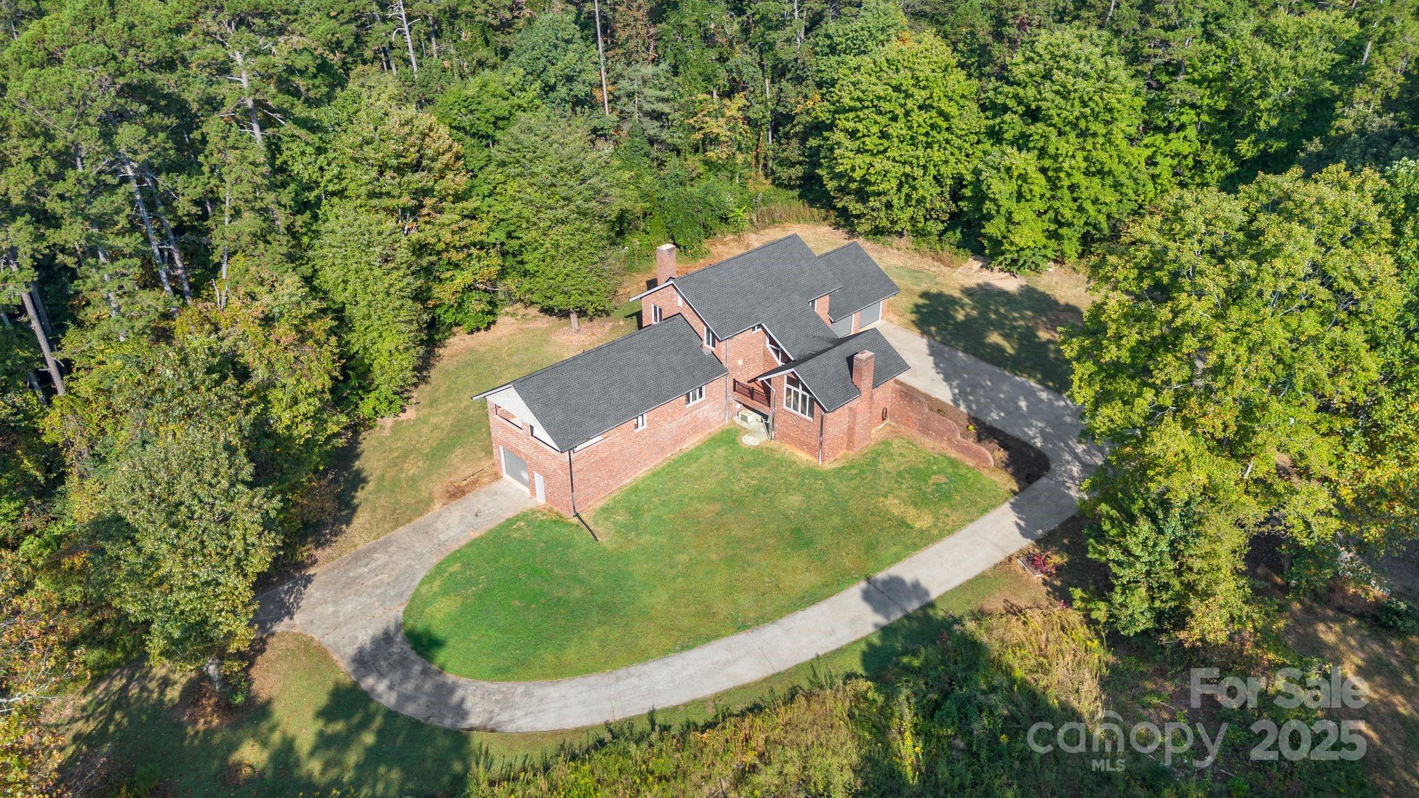 1653 Dudley Shoals Road Granite Falls, NC 28630 - Photo 46 of 48 an aerial view of a house with outdoor space and trees all around