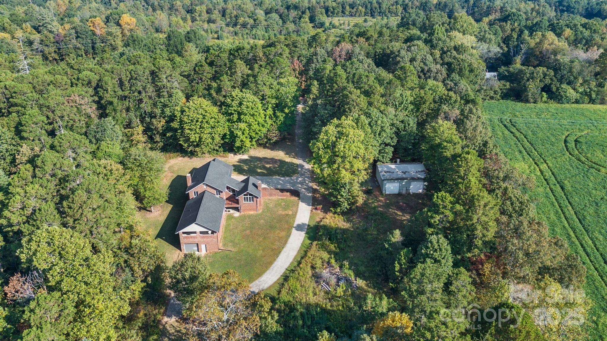 1653 Dudley Shoals Road Granite Falls, NC 28630 - Photo 47 of 48 an aerial view of a house with a yard and trees
