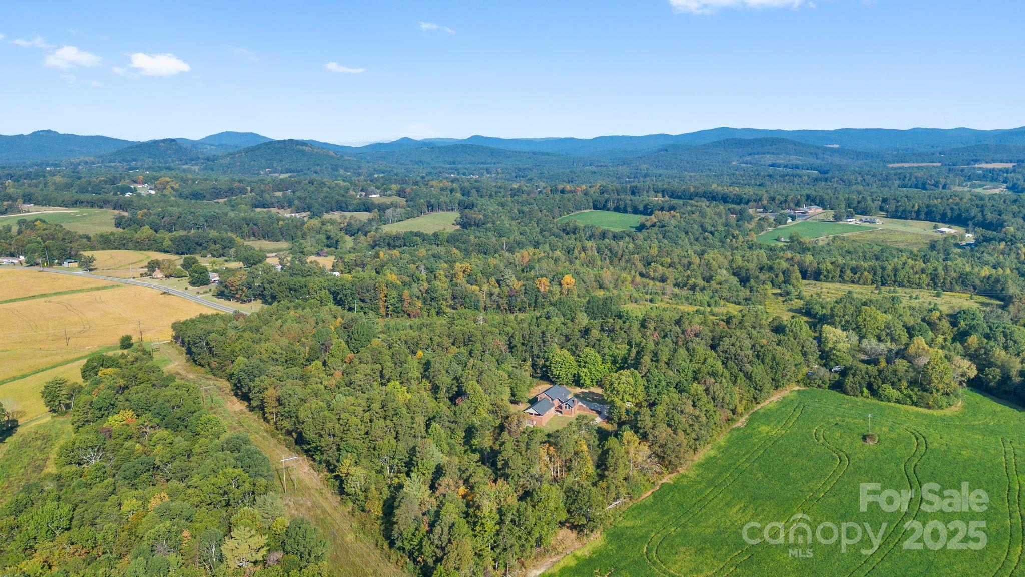 1653 Dudley Shoals Road Granite Falls, NC 28630 - Photo 48 of 48 a view of a lush green hillside and a houses