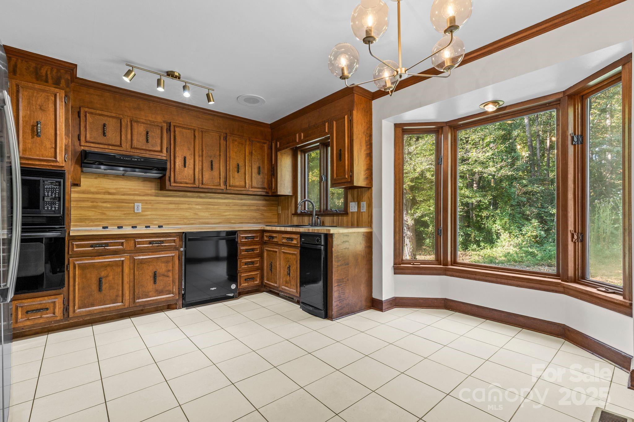 1653 Dudley Shoals Road Granite Falls, NC 28630 - Photo 8 of 48 a kitchen with stainless steel appliances granite countertop a stove a sink and a microwave