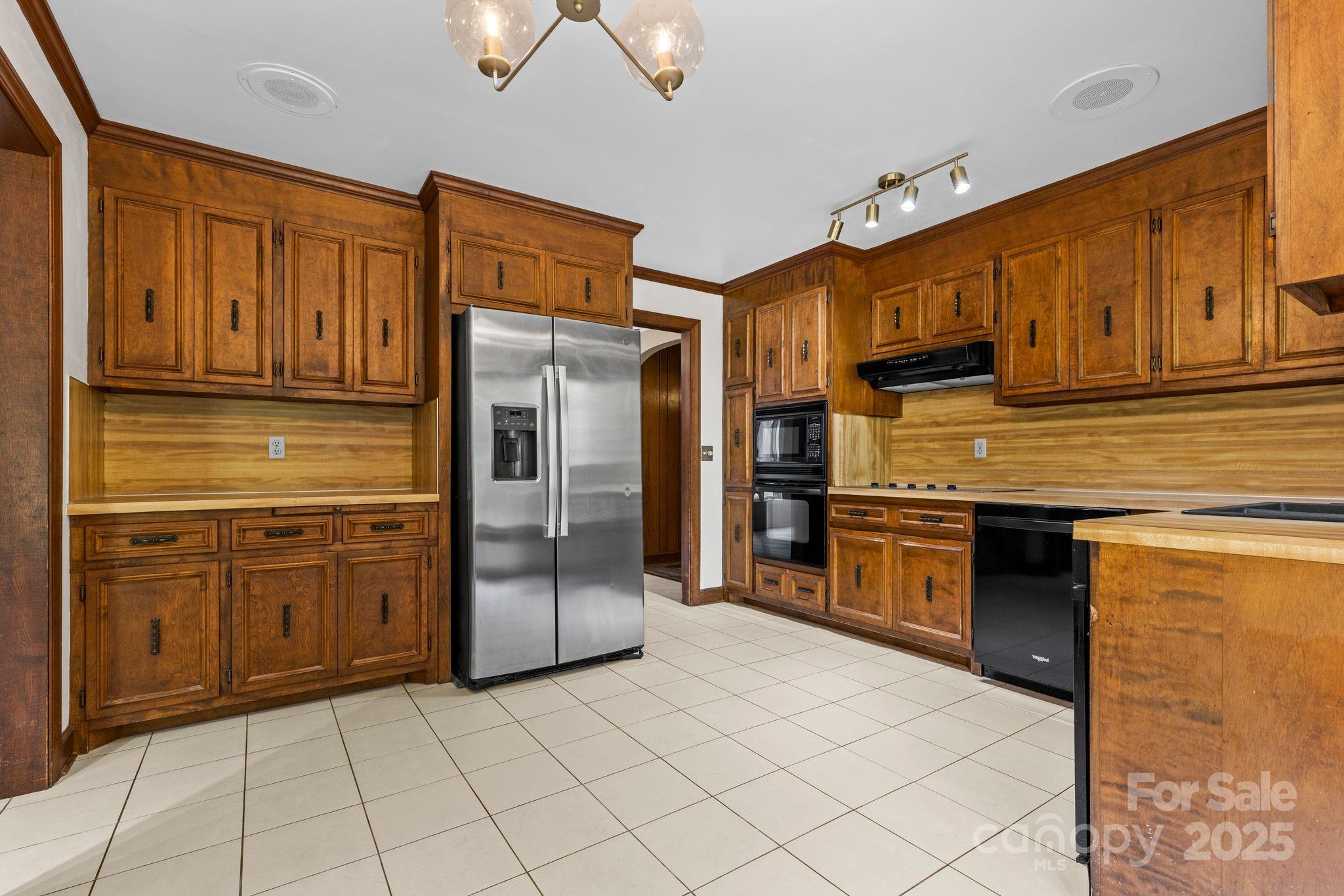 1653 Dudley Shoals Road Granite Falls, NC 28630 - Photo 9 of 48 a kitchen with stainless steel appliances granite countertop a refrigerator and a stove top oven