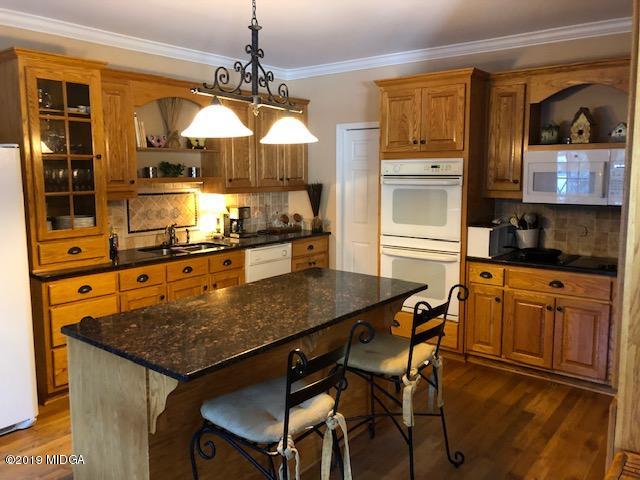 577 Old Popes Ferry Road Juliette, GA 31046 - Photo 15 of 49 a kitchen with stainless steel appliances granite countertop a stove a sink and a refrigerator