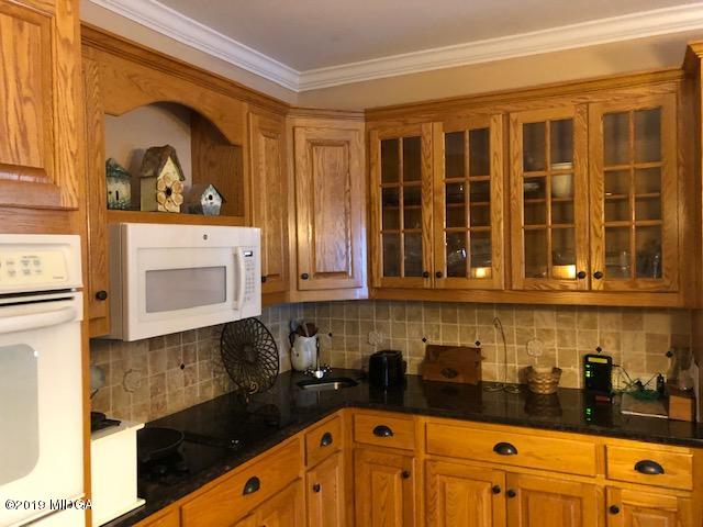 577 Old Popes Ferry Road Juliette, GA 31046 - Photo 16 of 49 a kitchen with a sink and cabinets