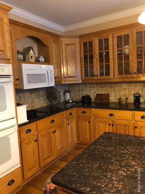 577 Old Popes Ferry Road Juliette, GA 31046 - Photo 17 of 49 a kitchen with stainless steel appliances granite countertop a stove a sink and a microwave