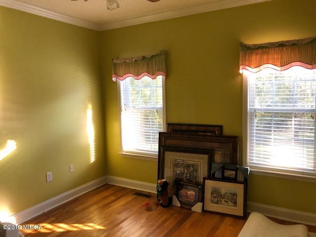 577 Old Popes Ferry Road Juliette, GA 31046 - Photo 21 of 49 a living room with a fireplace and a window