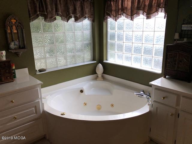 577 Old Popes Ferry Road Juliette, GA 31046 - Photo 25 of 49 a bathroom with a bathtub and next to a window