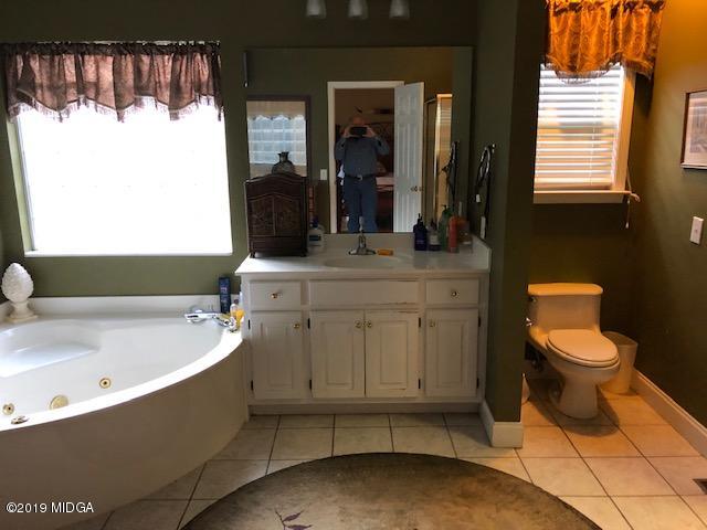 577 Old Popes Ferry Road Juliette, GA 31046 - Photo 26 of 49 a bathroom with a sink a toilet and a bathtub