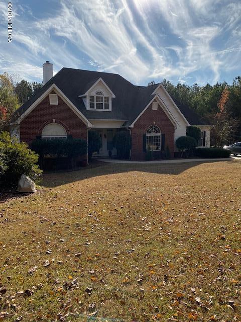 577 Old Popes Ferry Road Juliette, GA 31046 - Photo 4 of 49 a front view of a house with a yard and garage