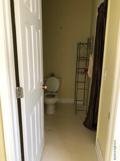 577 Old Popes Ferry Road Juliette, GA 31046 - Photo 33 of 49 a bathroom with a toilet and a shower curtain