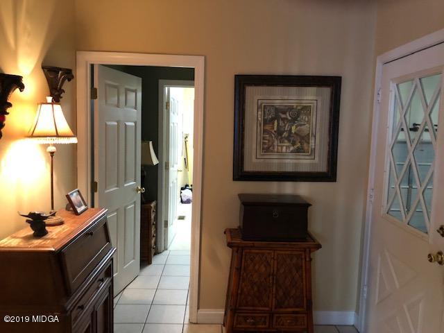 577 Old Popes Ferry Road Juliette, GA 31046 - Photo 34 of 49 a hallway with a large mirror and a dresser