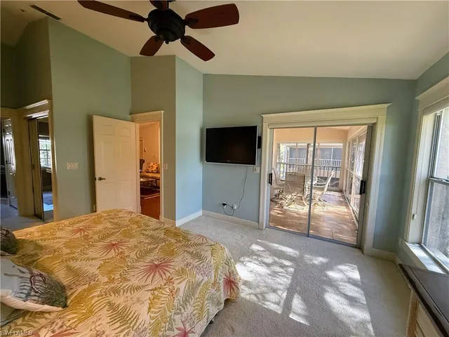 a bedroom with a bed and a flat tv screen