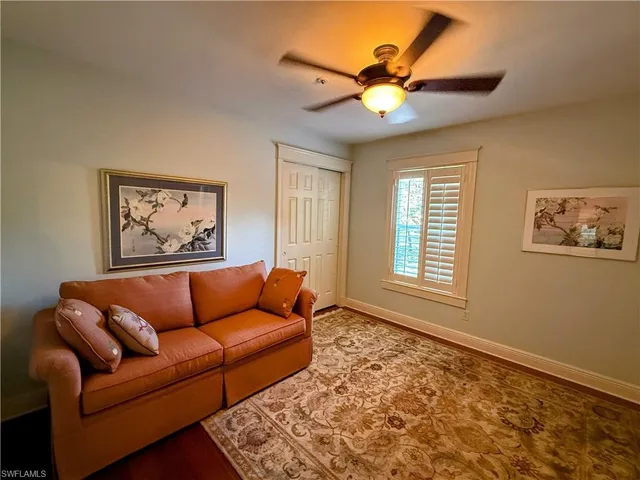 a blue couch sitting in a living room next to a window