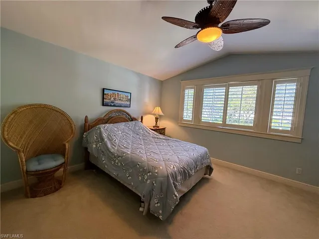 a spacious bedroom with a bed and window