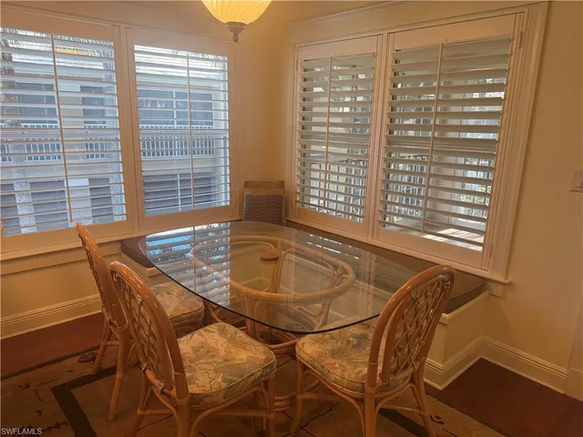 a view of a dining room with furniture and windows