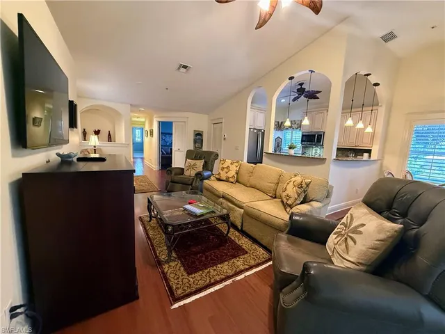a living room with furniture and a chandelier