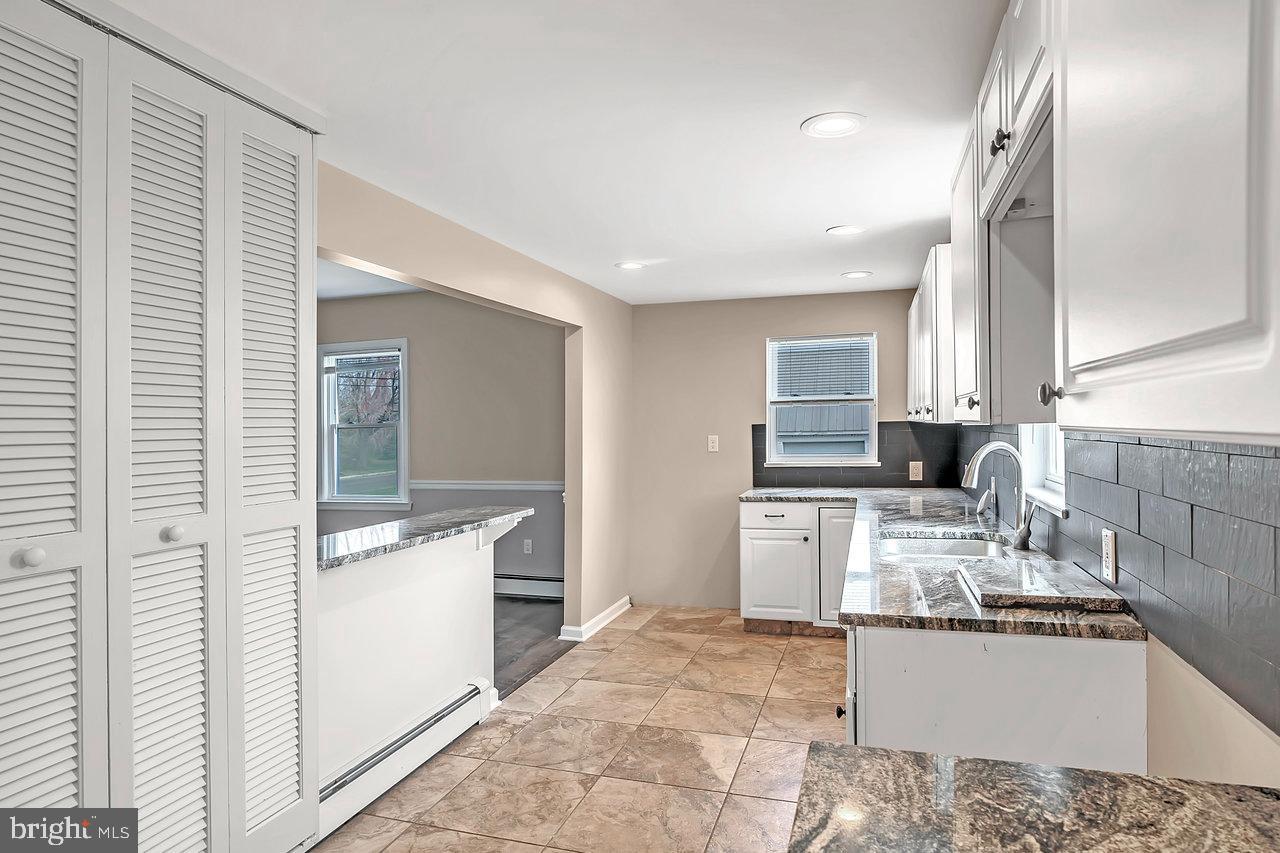 342 Sharon Road Hightstown, NJ 08520 - Photo 8 of 30 a kitchen with a sink stove and refrigerator