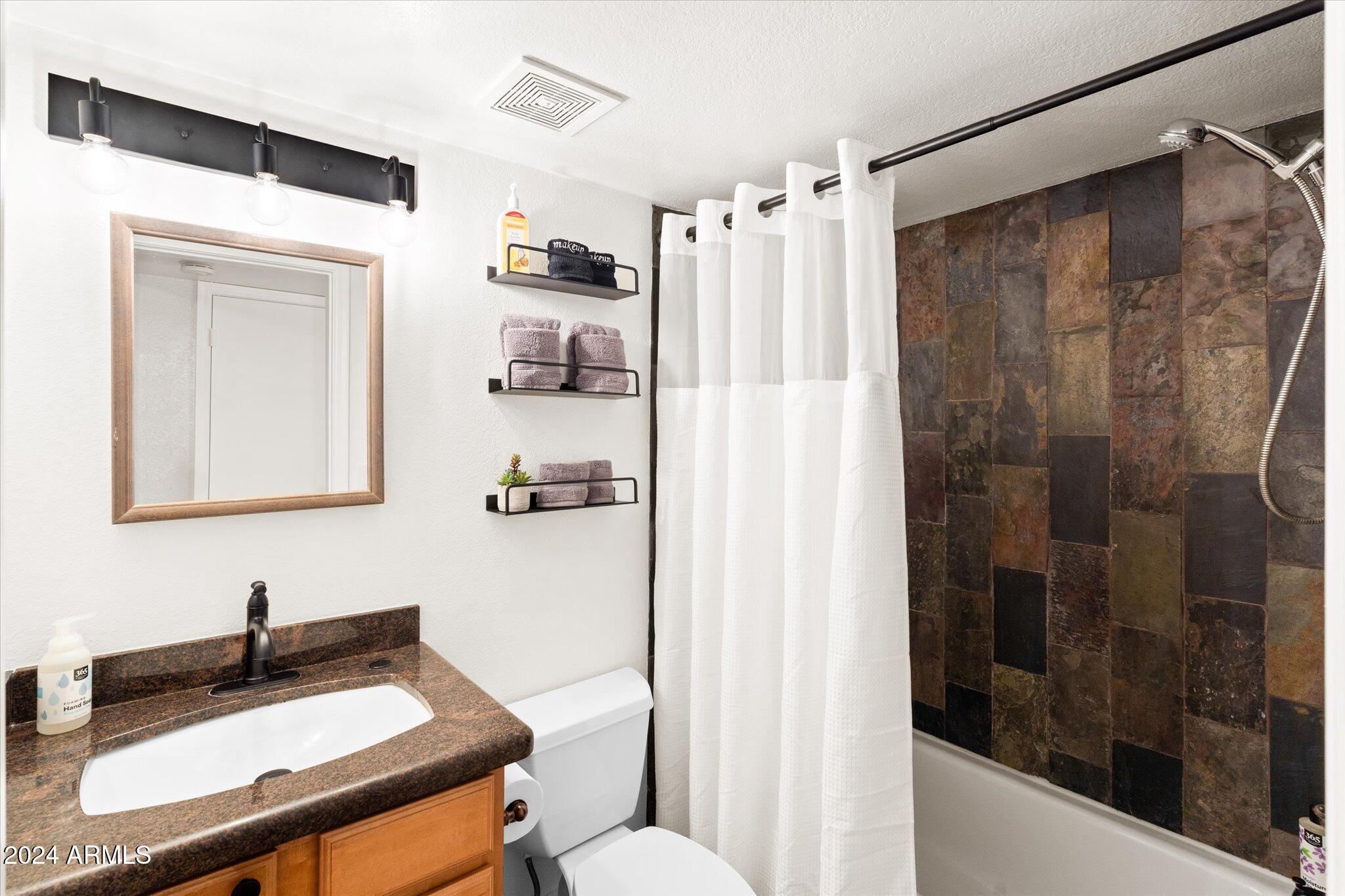 533 West Guadalupe Road, Unit 1063 Mesa, AZ 85210 - Photo 22 of 57 a bathroom with a sink a toilet and shower