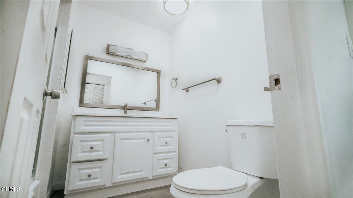 1361 Edgewood Way, Unit 61 Oxnard, CA 93030 - Photo 13 of 22 a bathroom with a toilet sink vanity and mirror