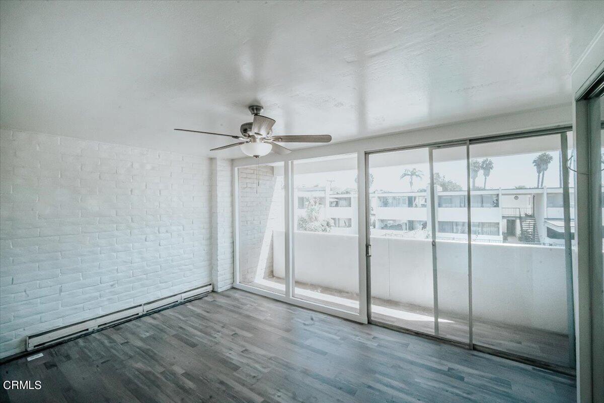 1361 Edgewood Way, Unit 61 Oxnard, CA 93030 - Photo 17 of 22 an empty room with wooden floor fan and windows
