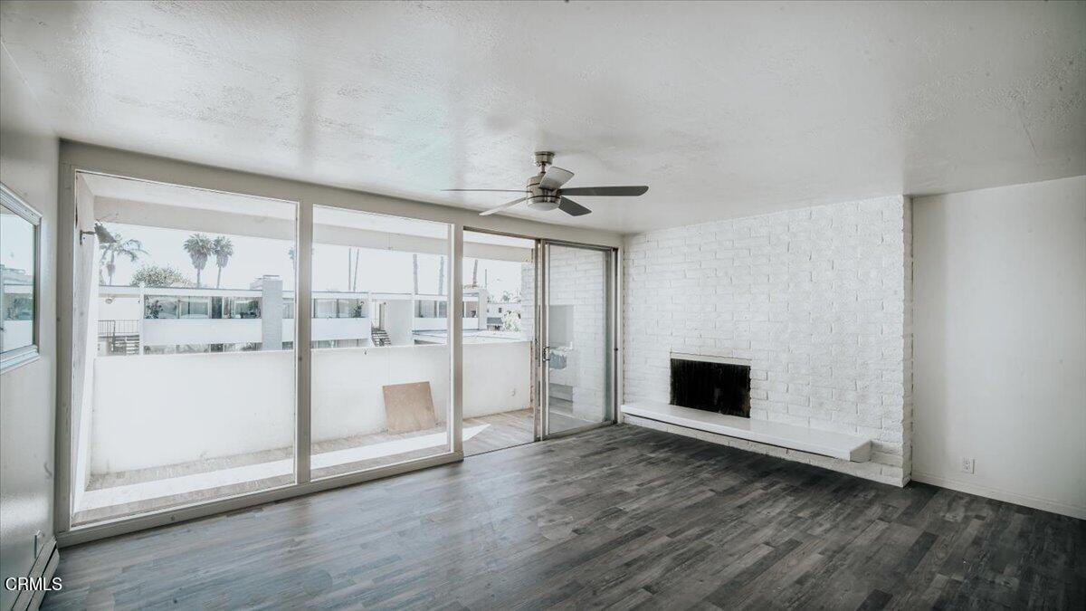1361 Edgewood Way, Unit 61 Oxnard, CA 93030 - Photo 2 of 22 a view of a livingroom with wooden floor and a ceiling fan