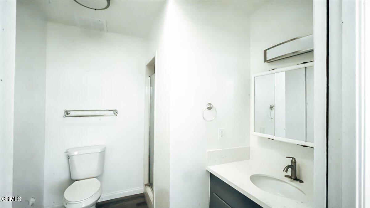 1361 Edgewood Way, Unit 61 Oxnard, CA 93030 - Photo 21 of 22 a bathroom with a granite countertop sink toilet and shower