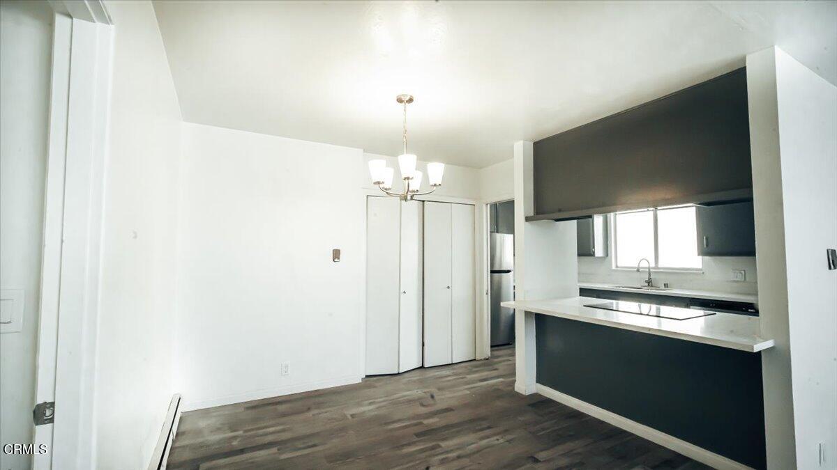 1361 Edgewood Way, Unit 61 Oxnard, CA 93030 - Photo 3 of 22 a view of kitchen with granite countertop cabinets and refrigerator