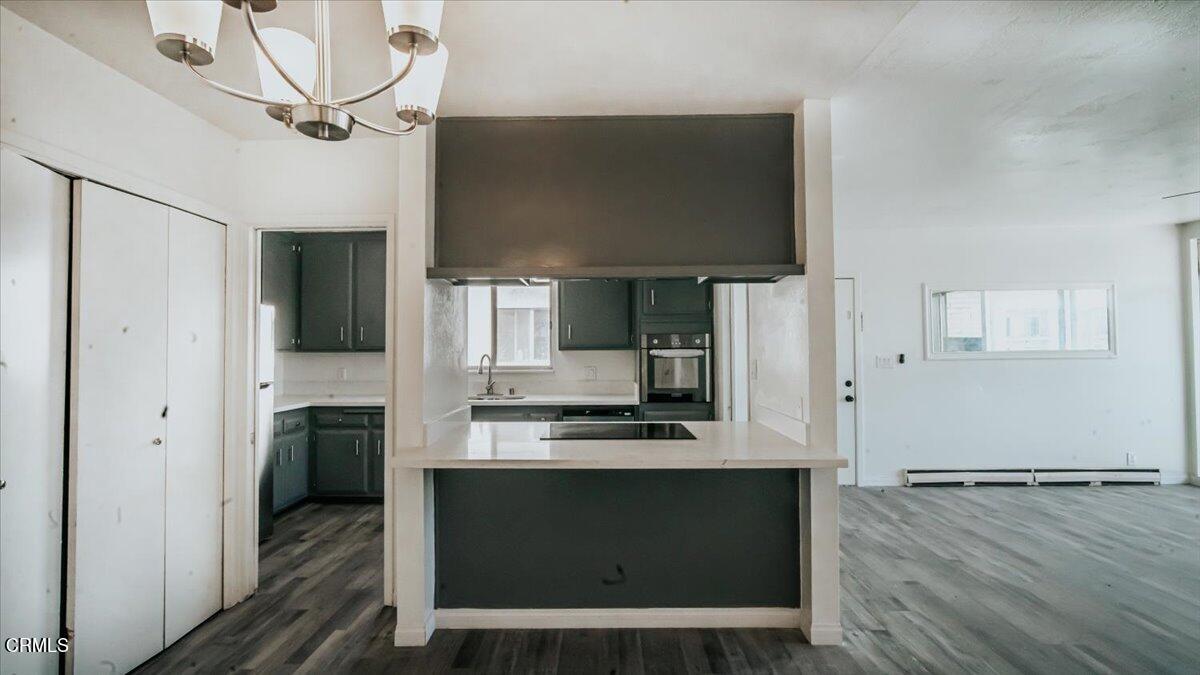 1361 Edgewood Way, Unit 61 Oxnard, CA 93030 - Photo 5 of 22 a kitchen with kitchen island a counter top space appliances and cabinets