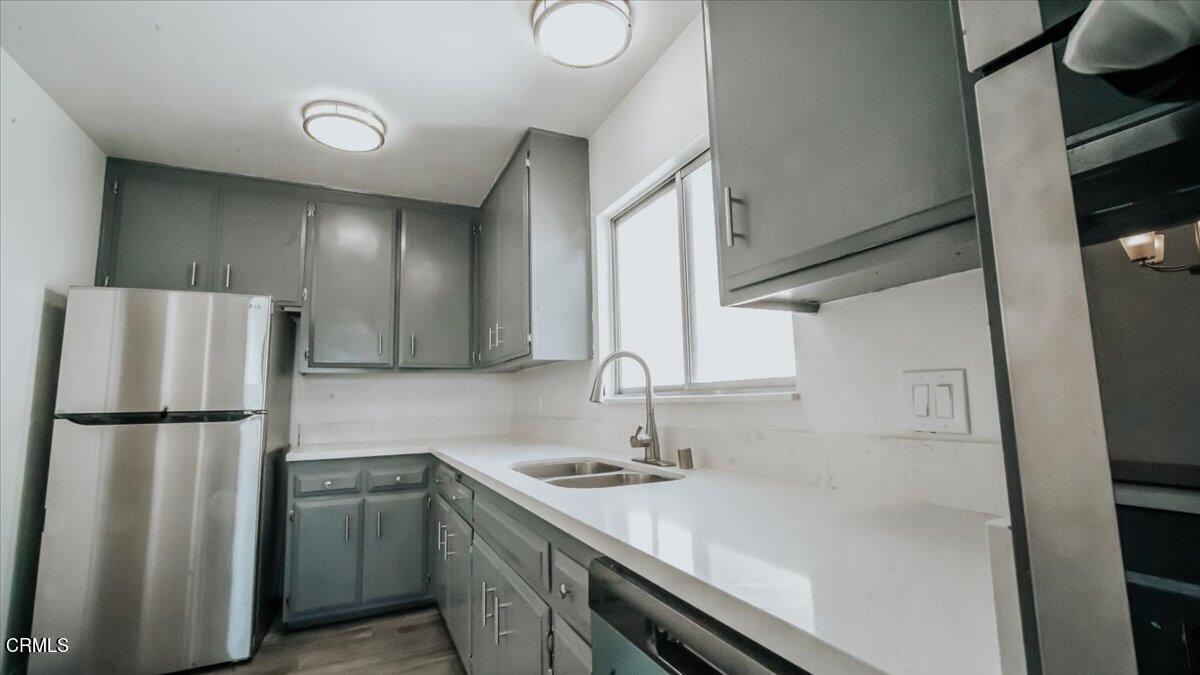 1361 Edgewood Way, Unit 61 Oxnard, CA 93030 - Photo 7 of 22 a kitchen with a refrigerator and a sink
