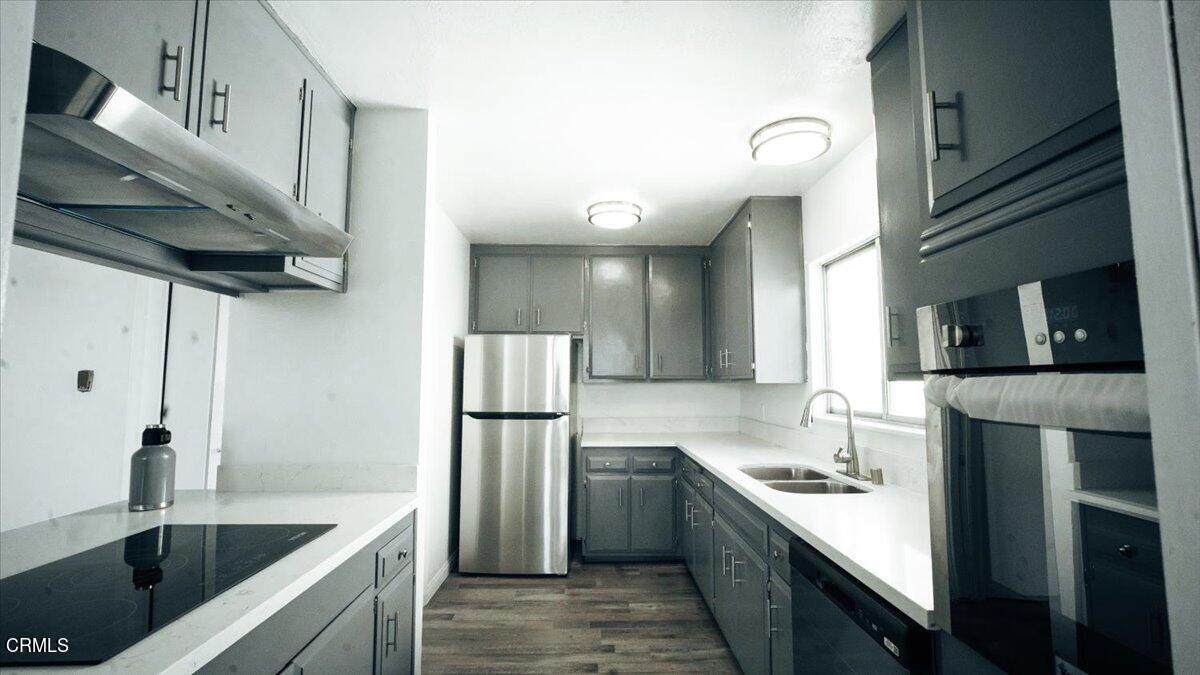 1361 Edgewood Way, Unit 61 Oxnard, CA 93030 - Photo 9 of 22 a kitchen with stainless steel appliances granite countertop a sink a stove and a refrigerator