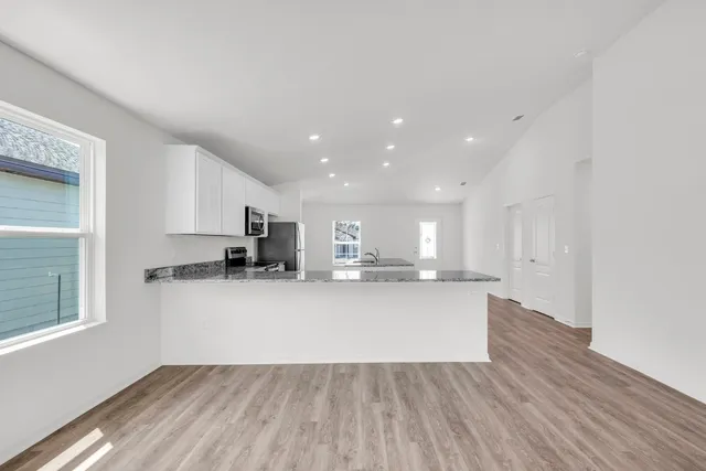 a view of kitchen with wooden floor