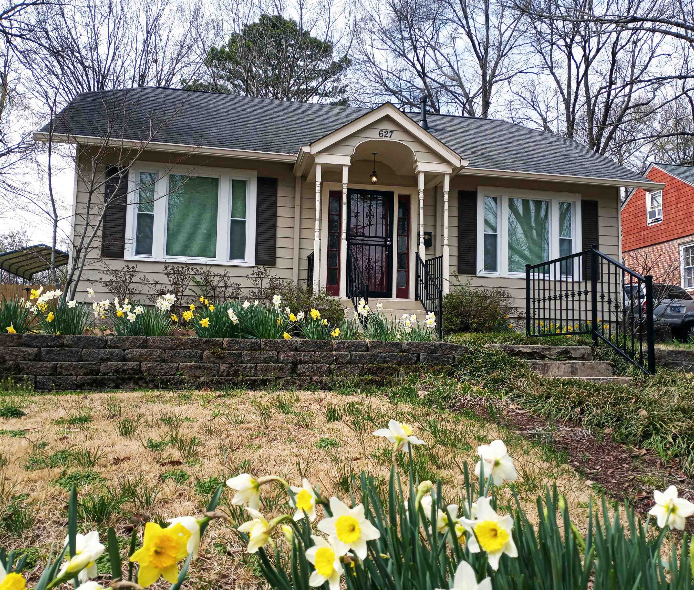 627 Watson Street Memphis, TN 38111 - Photo 1 of 35 a front view of a house with a yard and a garden