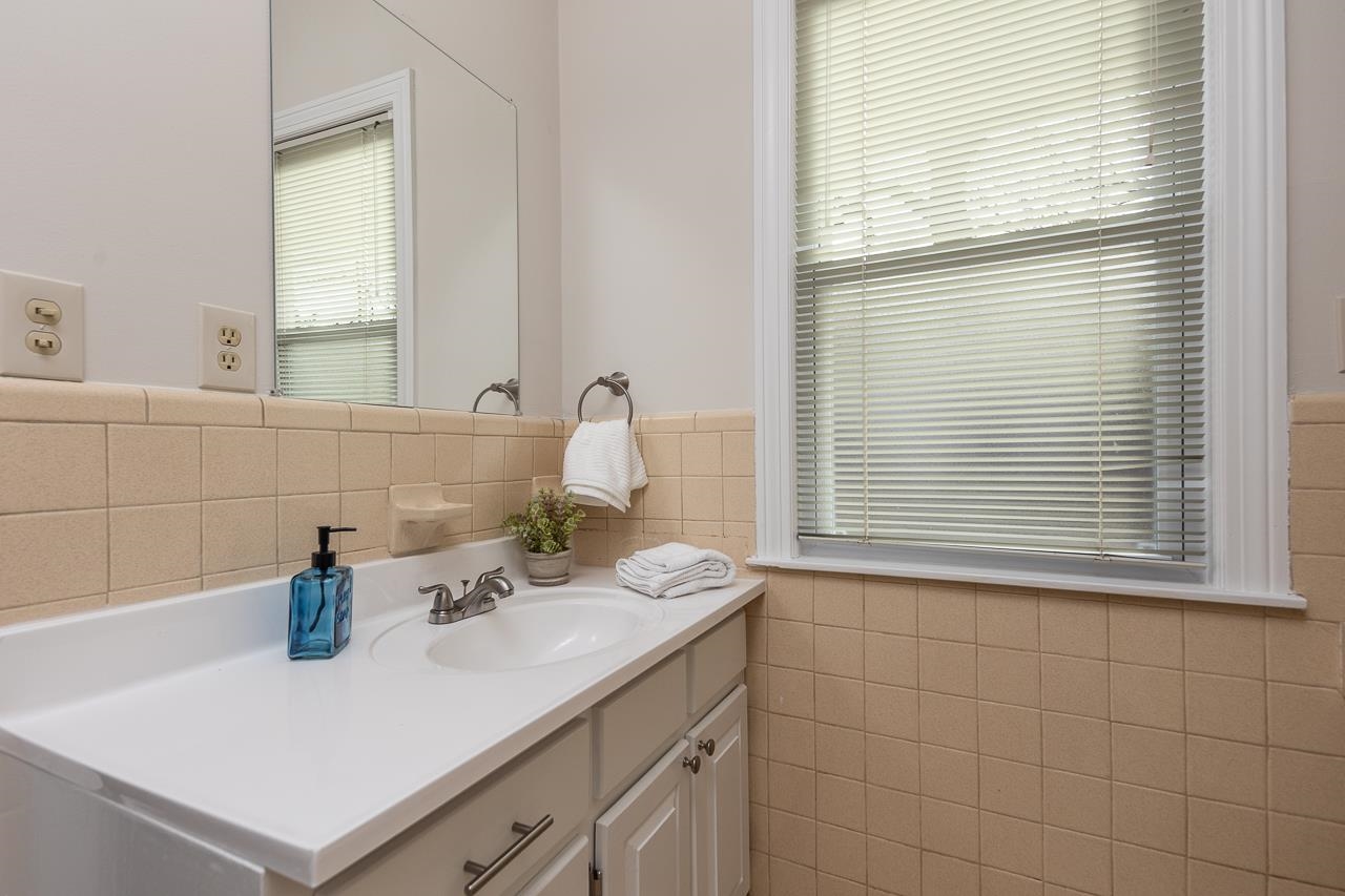 627 Watson Street Memphis, TN 38111 - Photo 17 of 35 a bathroom with a sink cabinets and a window