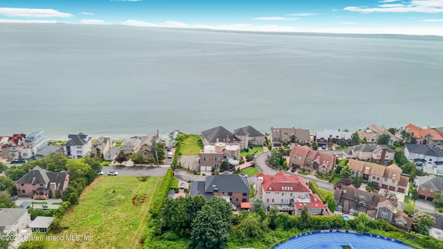 a large kitchen with kitchen island a stove a sink a refrigerator and a dining table with wooden floor