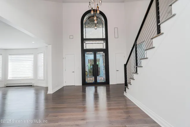 a dining room with furniture a rug and a chandelier