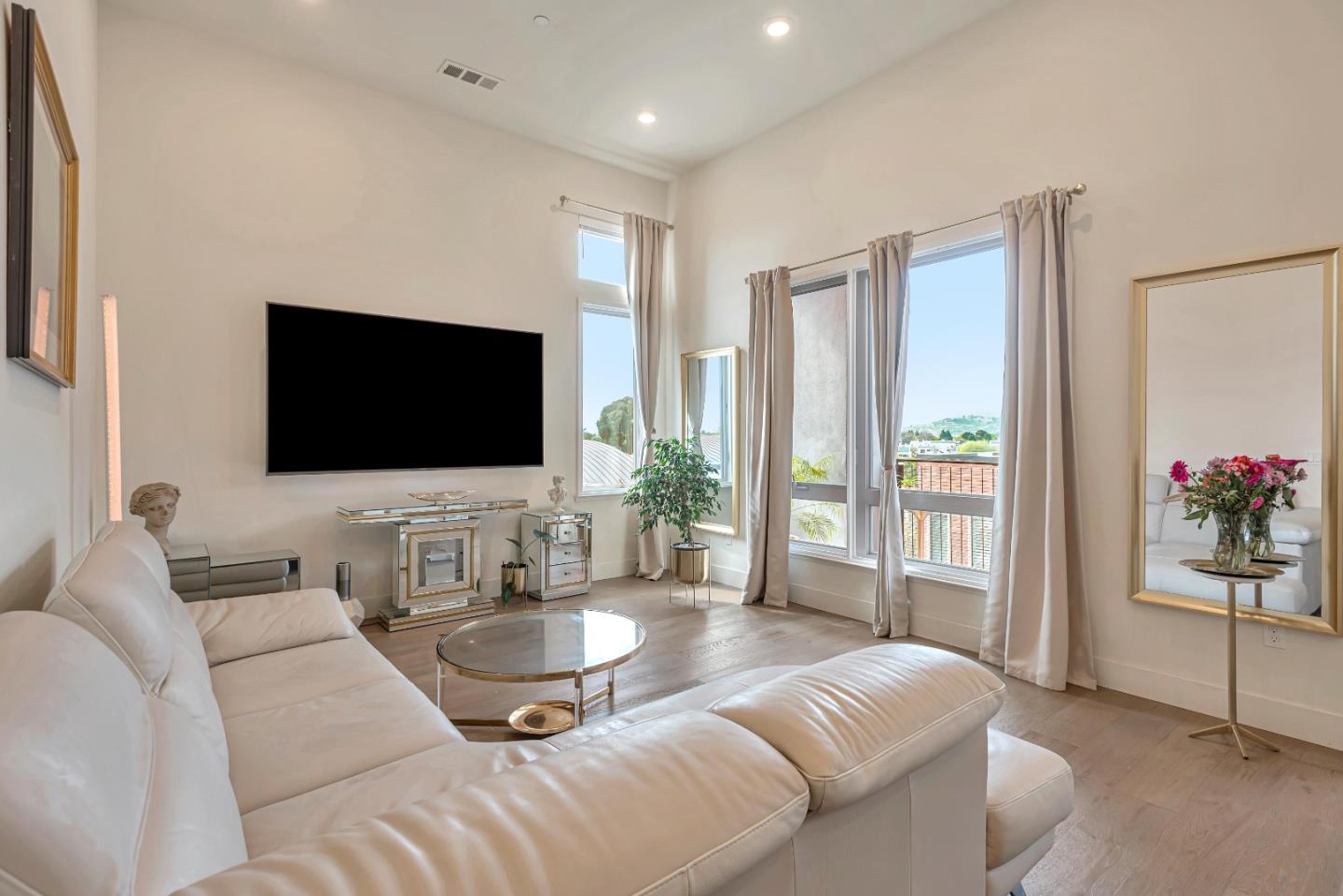 1038 Foster Square Lane, Unit 403 Foster City, CA 94404 - Photo 11 of 28 a living room with furniture and a flat screen tv