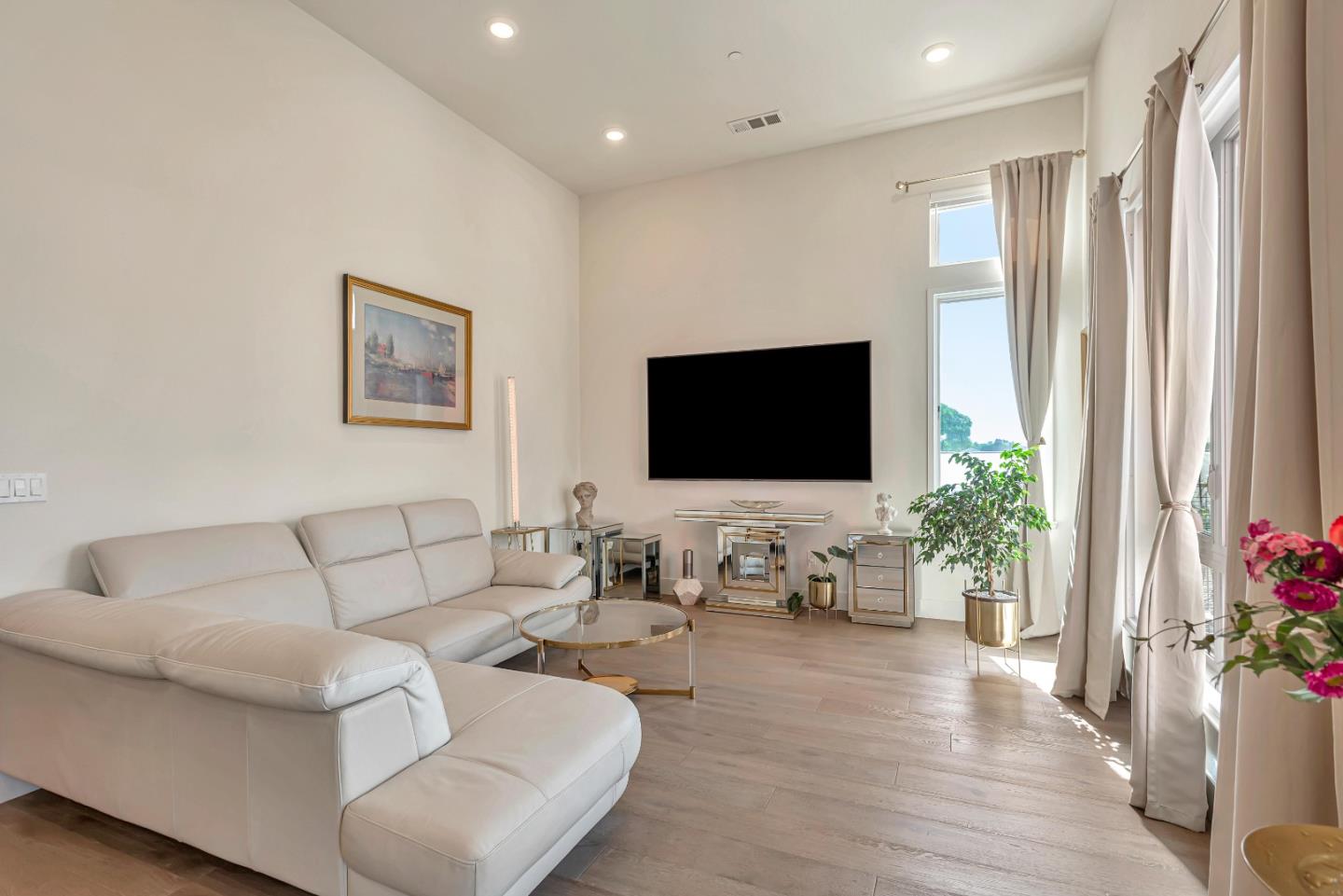 1038 Foster Square Lane, Unit 403 Foster City, CA 94404 - Photo 12 of 28 a living room with furniture and a flat screen tv