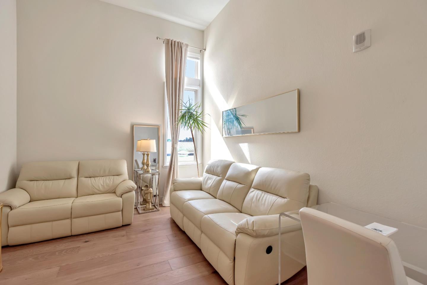 1038 Foster Square Lane, Unit 403 Foster City, CA 94404 - Photo 13 of 28 a living room with furniture and a couch