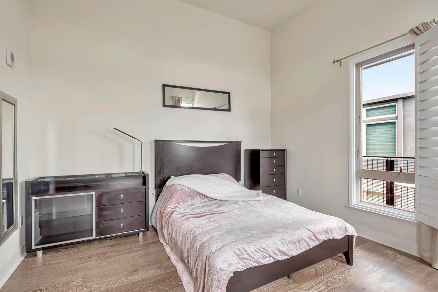 1038 Foster Square Lane, Unit 403 Foster City, CA 94404 - Photo 17 of 28 a bedroom with a bed and a window