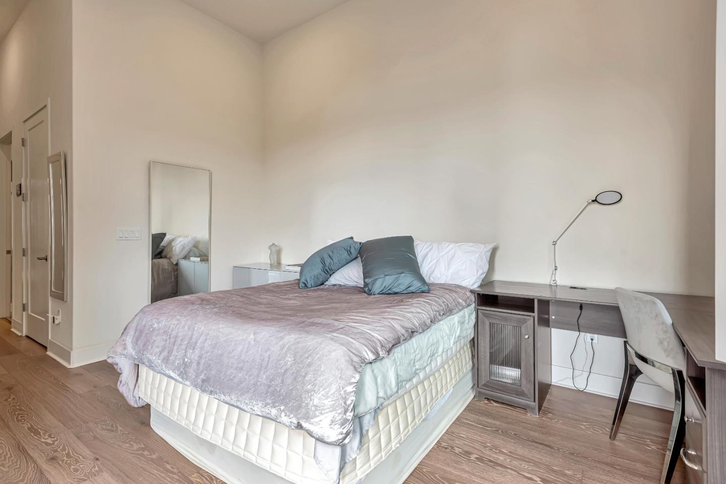 1038 Foster Square Lane, Unit 403 Foster City, CA 94404 - Photo 20 of 28 a bedroom with a bed and wooden floor