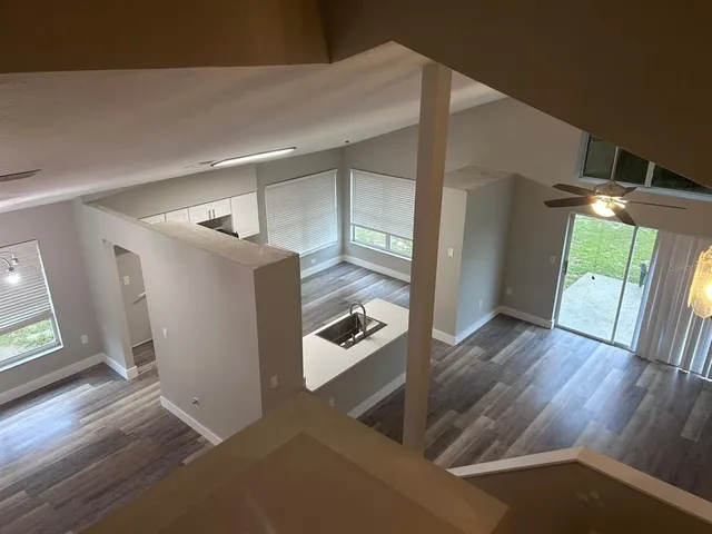 a view of a livingroom with wooden floor and furniture