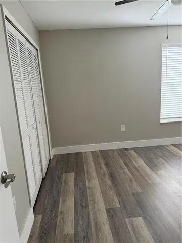 a view of a room with wooden floor and window