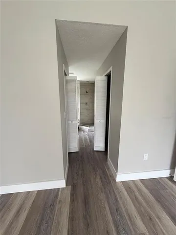 a view of a room with wooden floor and a toilet