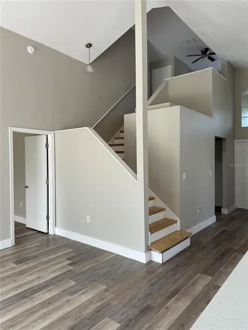 a view of entryway with stairs and wooden floor