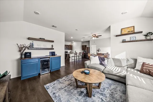 a living room with furniture and a wooden floor
