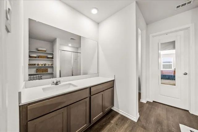 a bathroom with a double vanity sink and mirror