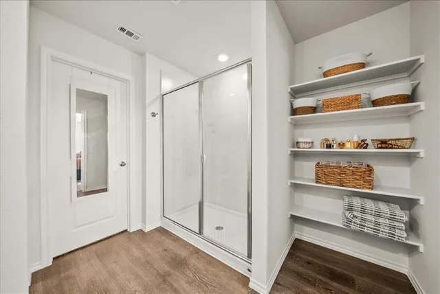a view of walk in closet with empty racks