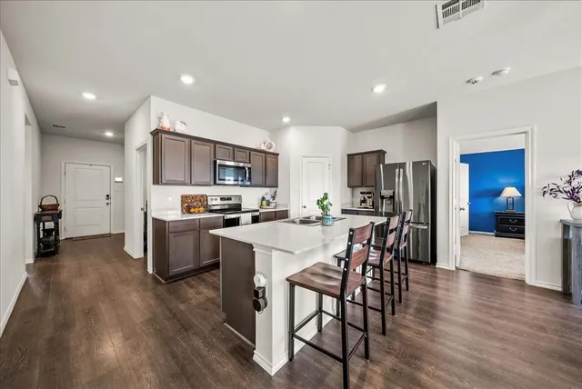 a kitchen with a table and chairs in it